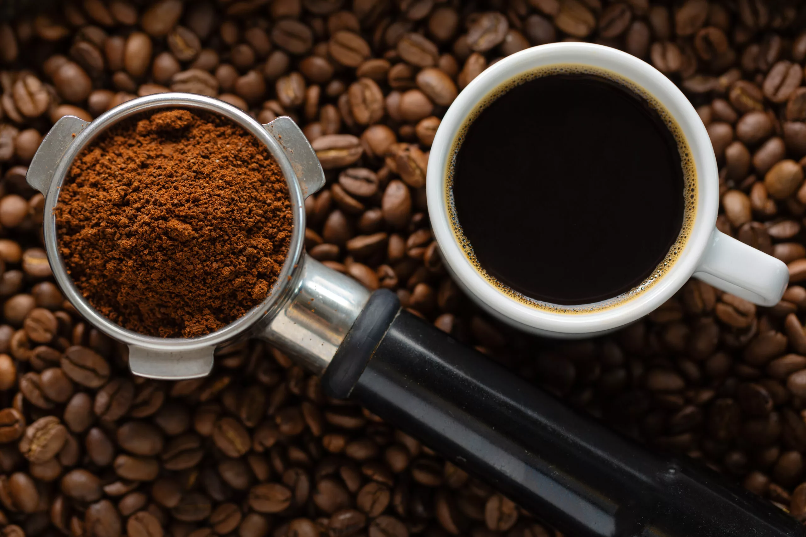 Coffee background. Coffee automatic from machine with coffee on coffee background. Closeup.