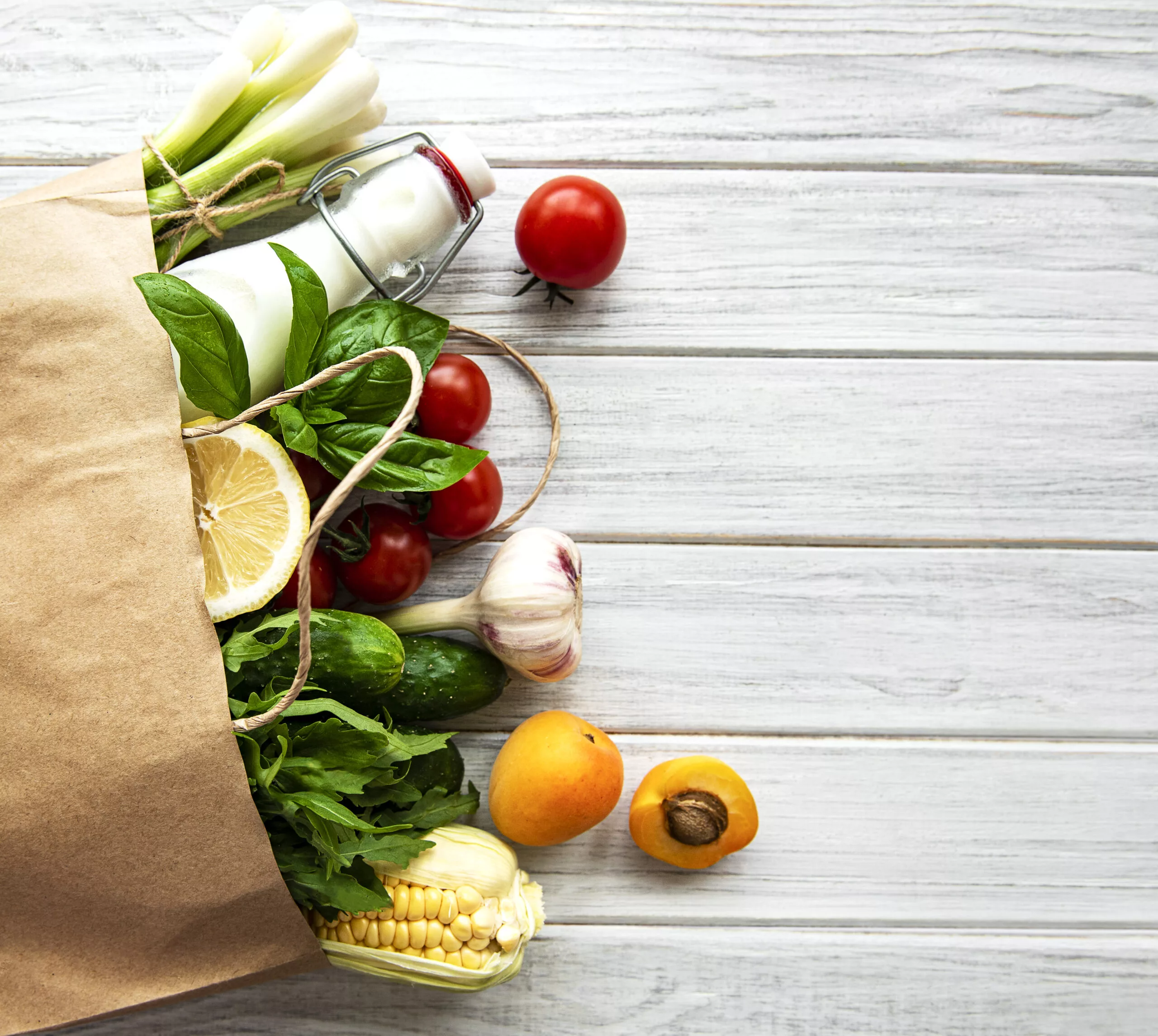 Healthy food background. Healthy food in paper bag, vegetables and fruits. Shopping food supermarket and clean vegan eating concept.